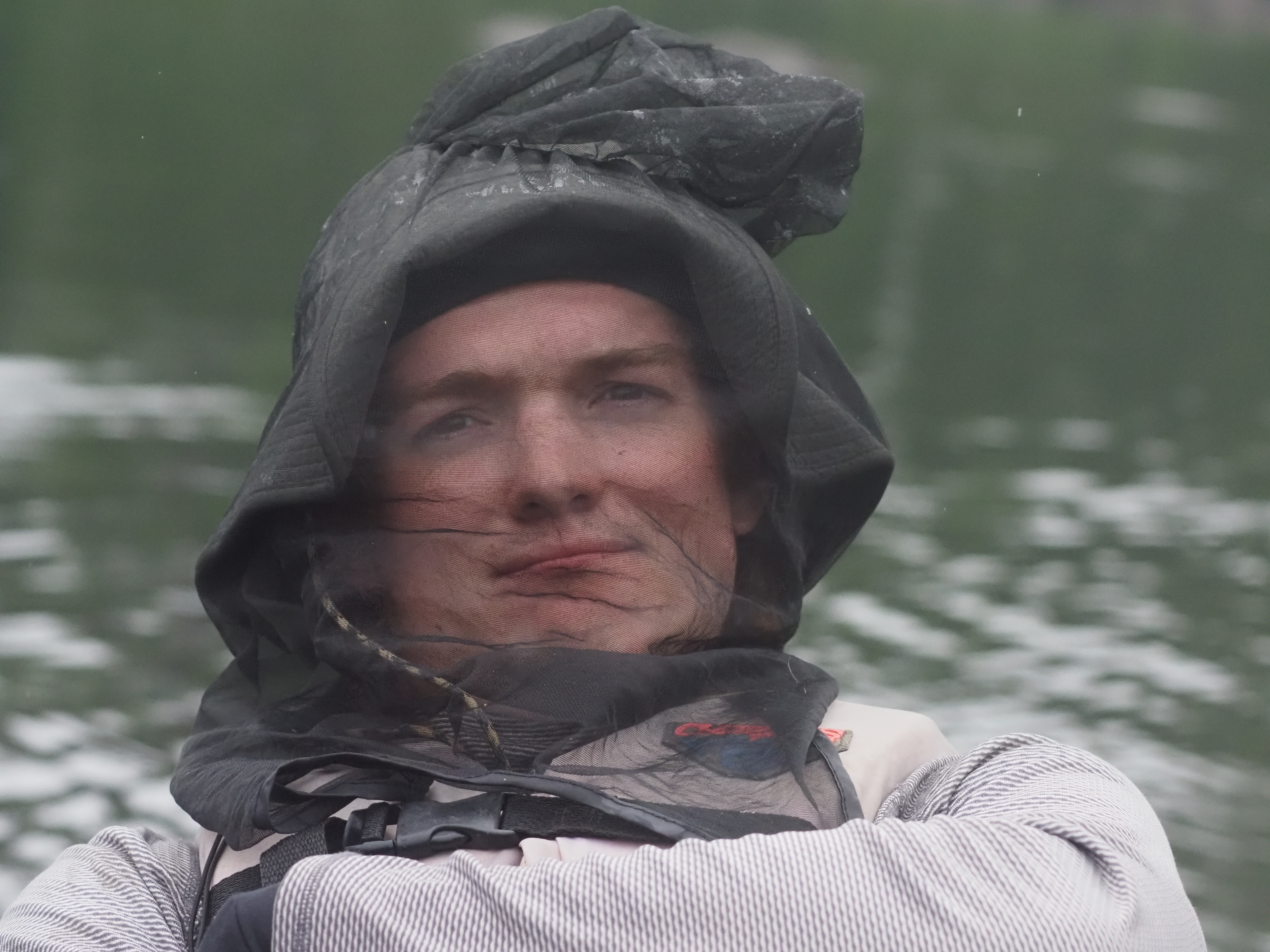 A man with a bug net on his face