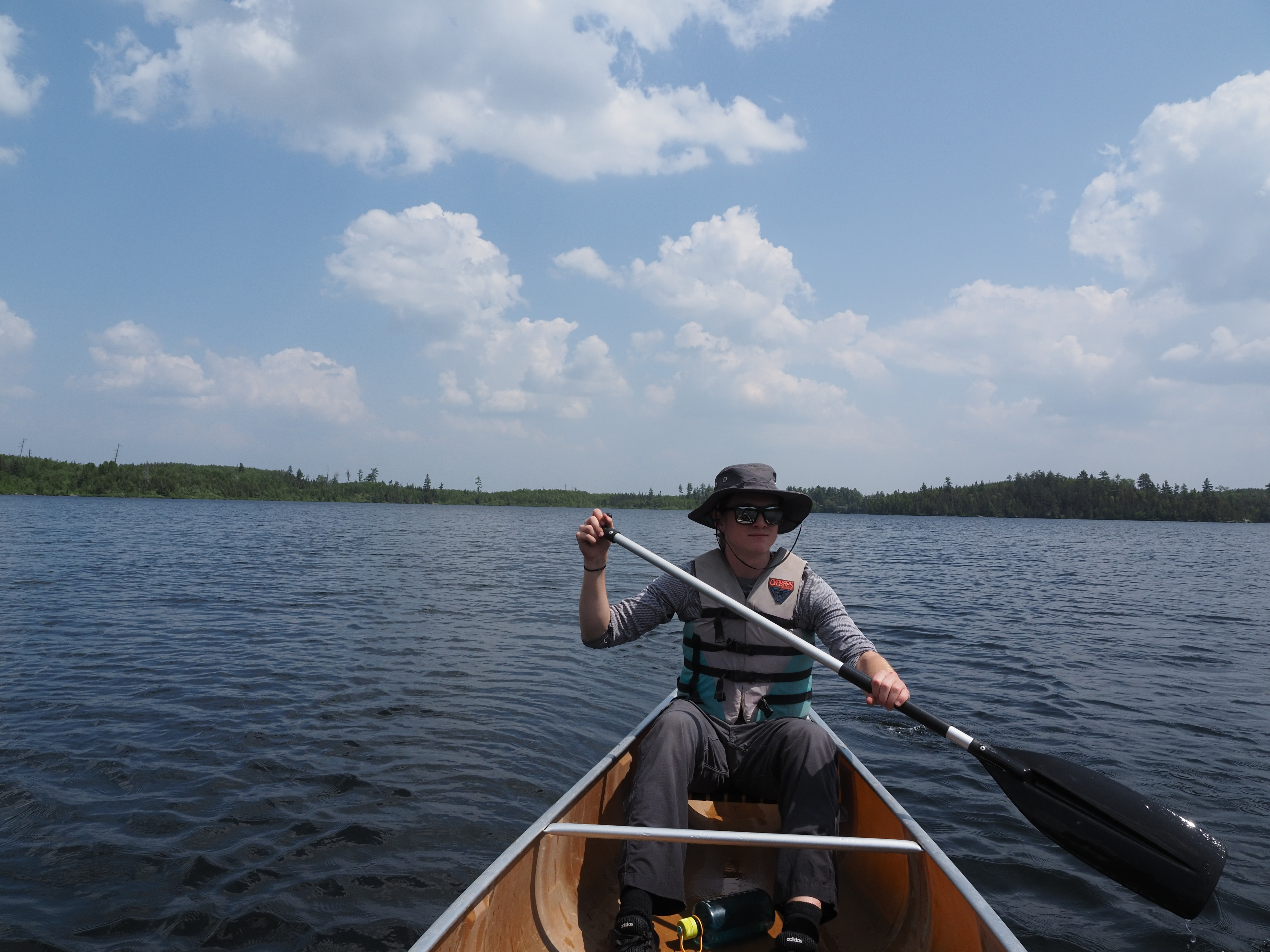 A man canoeing on a lake