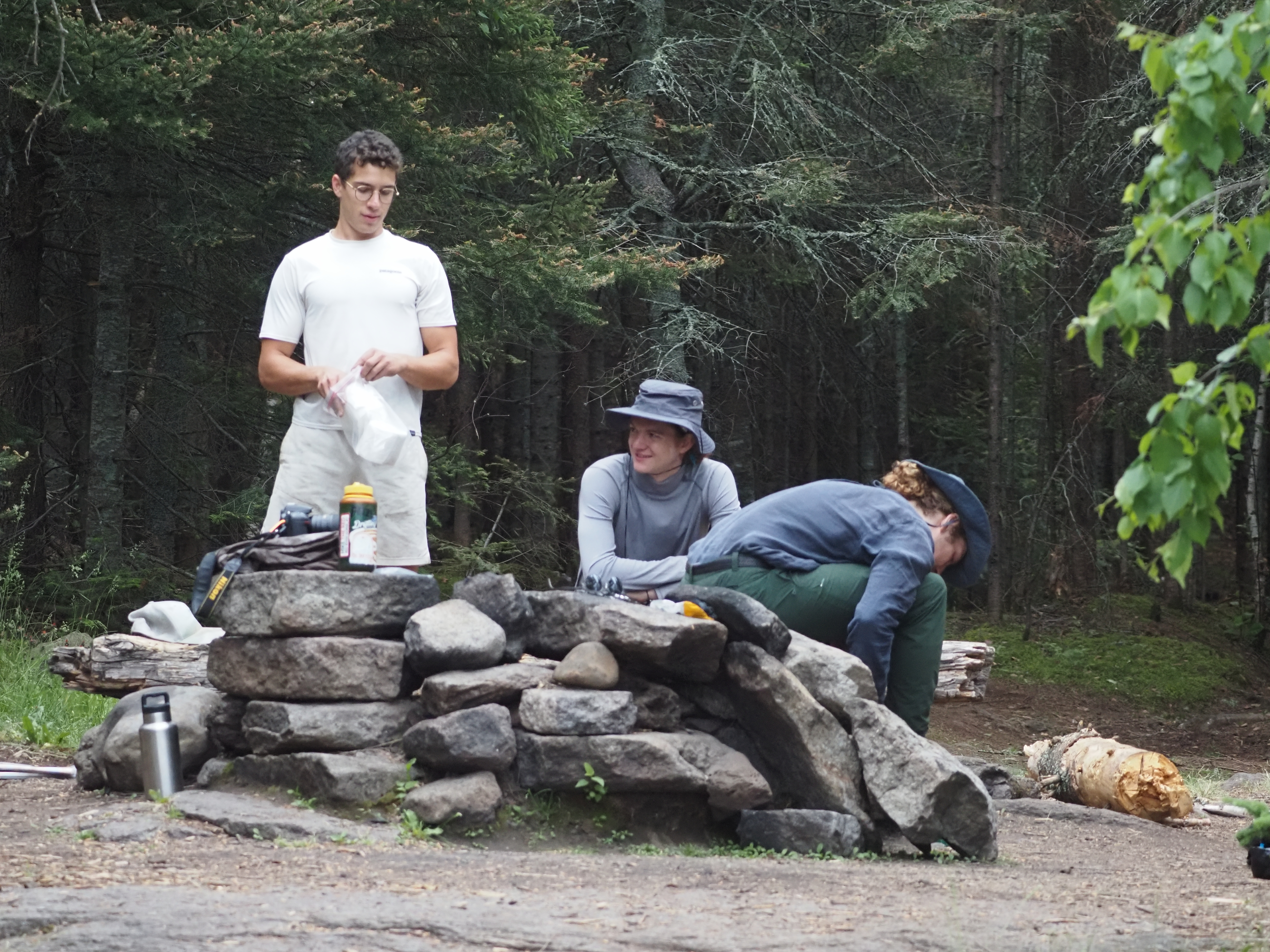 Three men at a campsite