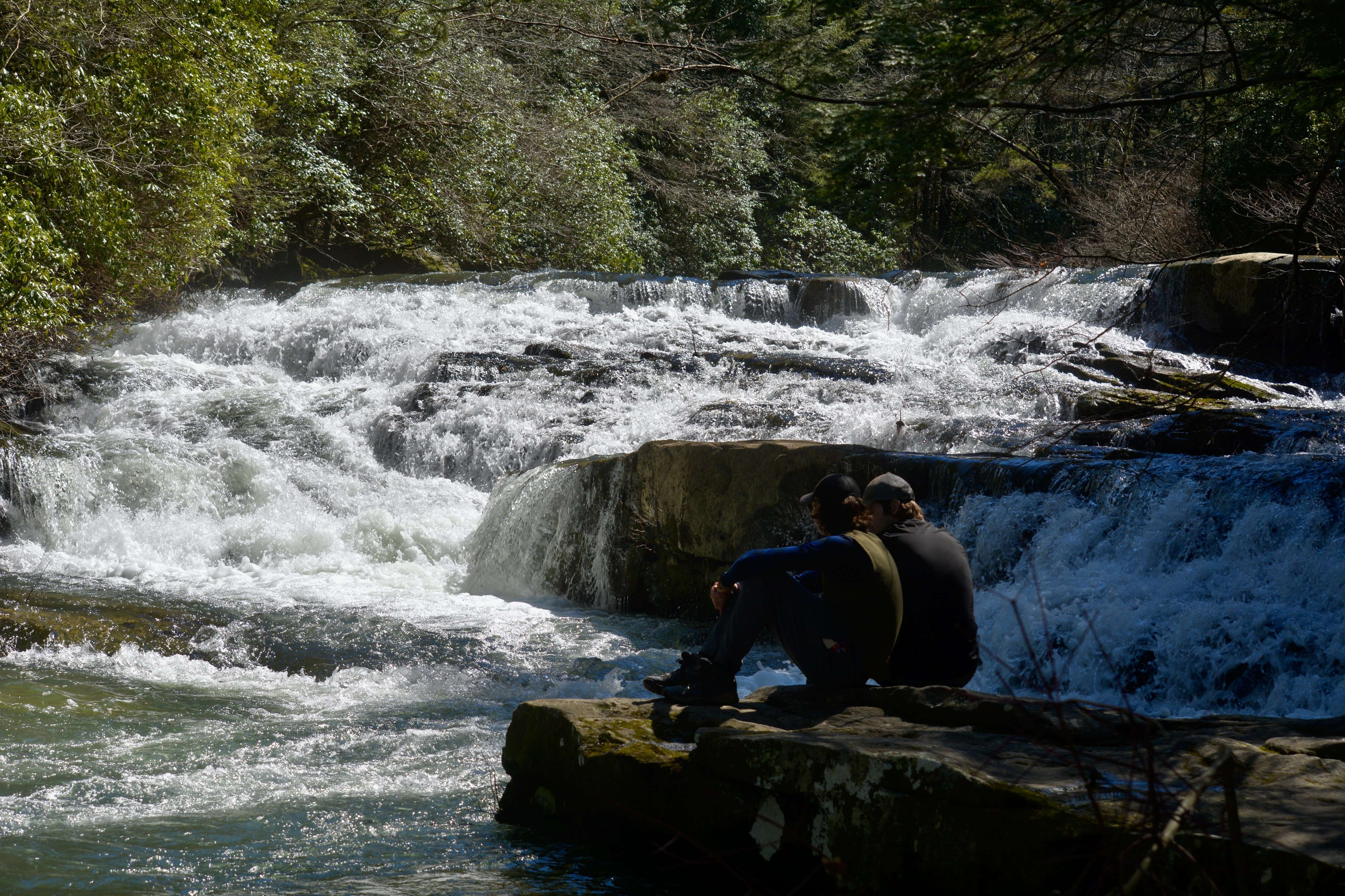 Two guys relaxing by a river
